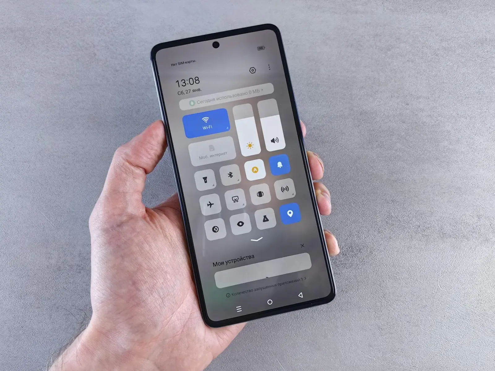 Close-up of a student's hands using a microlearning app on a tablet in a dorm room.