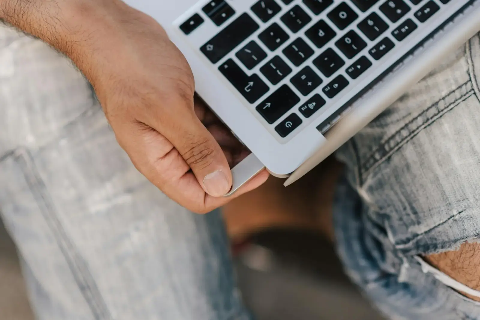 Close-up of a student's hands creating digital anatomy flashcards on a laptop